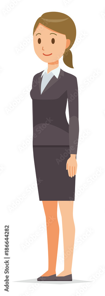 A business woman in a suit stands facing diagonally A business woman in a suit stands facing diagonally