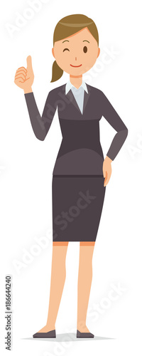 A business woman in a suit is doing a good sign