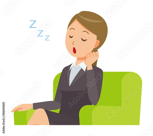 A business woman in a suit is falling asleep sitting on the sofa