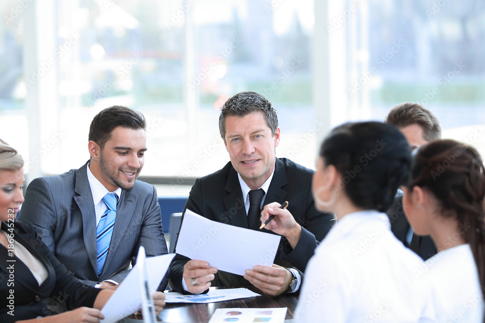 businessman and his business team discussing working papers. businessman and his business team discussing working papers.