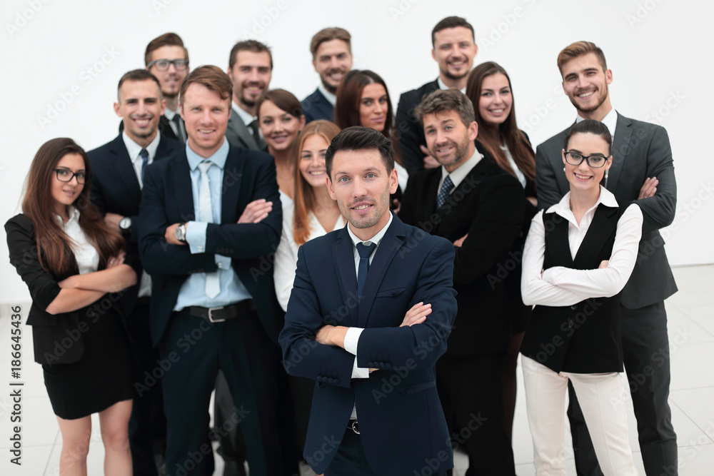 leader standing in front of a large business team leader standing in front of a large business team