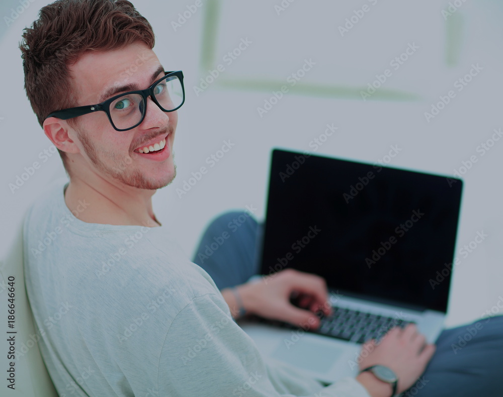 young man using laptop computer at home young man using laptop computer at home
