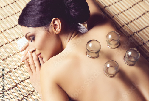 Healthy and beautiful woman getting massage treatment in spa salon. photo