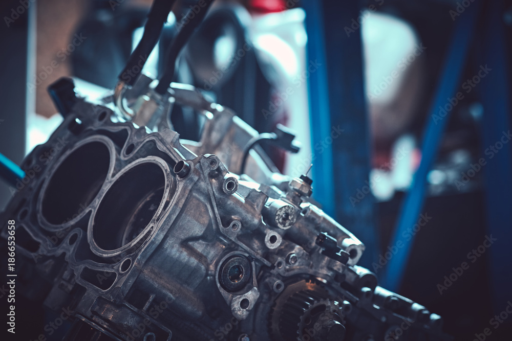 Car servicing, old piston at engine block after disassembly. Car servicing, old piston at engine block after disassembly.