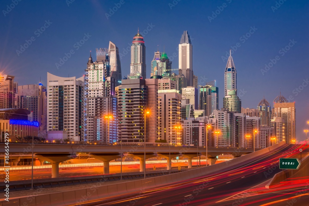 Dubai Marina Skyline at night in United Arab Emirates with light trails and skyscrapers at the background