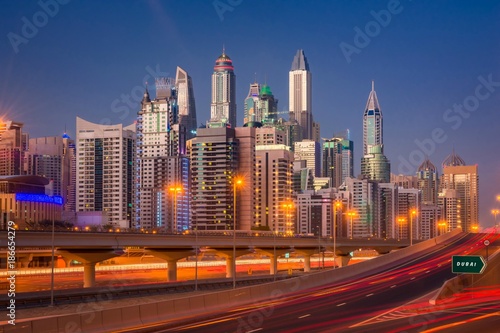 Dubai Marina Skyline at night in United Arab Emirates with light trails and skyscrapers at the background