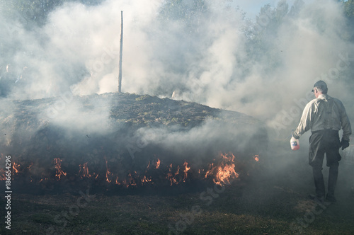 Man handling the traditional tar pit lighting