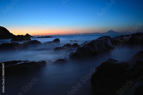 Mt. Fuji silhouette with reef at sunset slow shutter