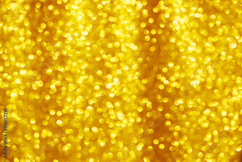 Gold glitter background. Shiny yellow christmas lighs bokeh.