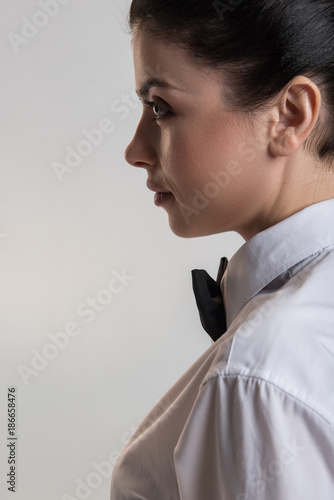 Hard decision. Experienced musing brunette woman posing in profile while reflecting and gazing straight