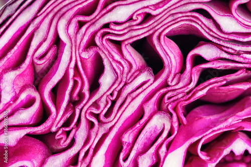Close up sliced or cut fresh purple or red cabbage in a half, top view flat lay to present surface and texture of cabbage use for background or wallpaper. Vegetable pattern concept in macro style.