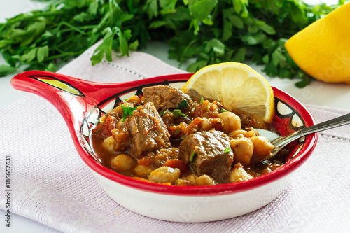 Delicious Moroccan soup harira with meat, chickpeas, lentils, tomatoes and spices. Tradition food for Iftar in holy month of Ramadan.