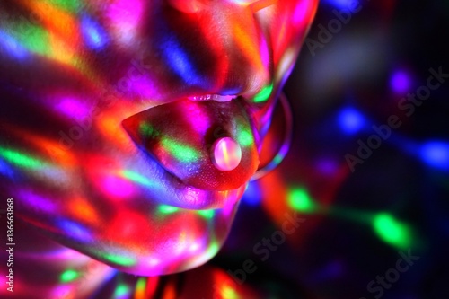 A young woman has ecstasy on her tongue in a night club.