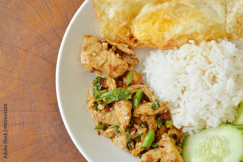 spicy stir fried chicken with basil leaf and egg on rice spicy stir fried chicken with basil leaf and egg on rice