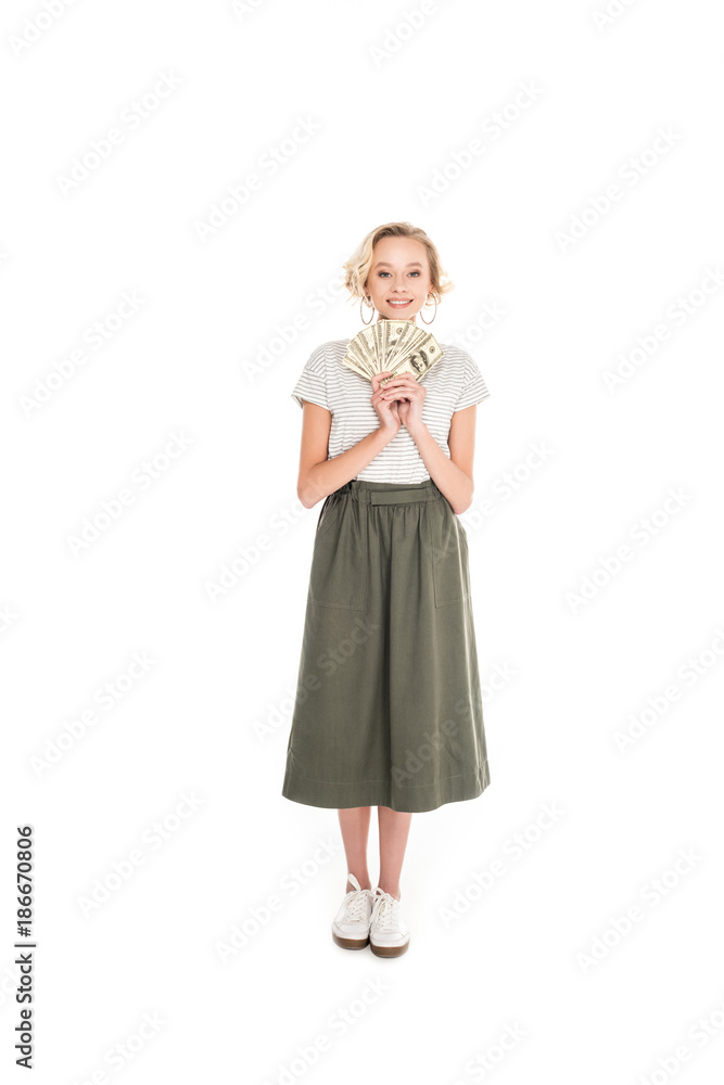 full length view of young woman holding dollar banknotes and smiling at camera isolated on white full length view of young woman holding dollar banknotes and smiling at camera isolated on white