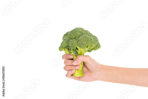 close-up partial view of female hand holding fresh organic broccoli isolated on white