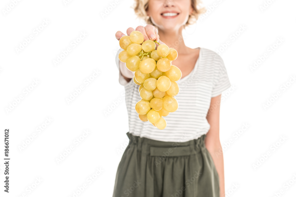 close-up partial view of smiling young woman holding fresh ripe grapes isolated on white close-up partial view of smiling young woman holding fresh ripe grapes isolated on white