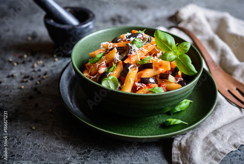Traditional Italian Pasta alla Norma with eggplant, tomato, cheese and basil