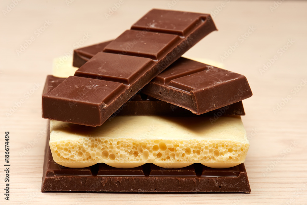 stack of four black and one white chocolate closeup stack of four black and one white chocolate closeup