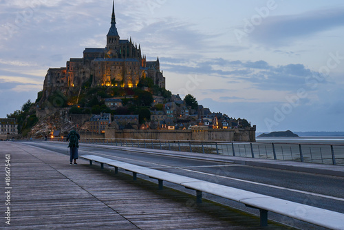 Backpacker in direction of Mont Saint Michel, Normandy, France
