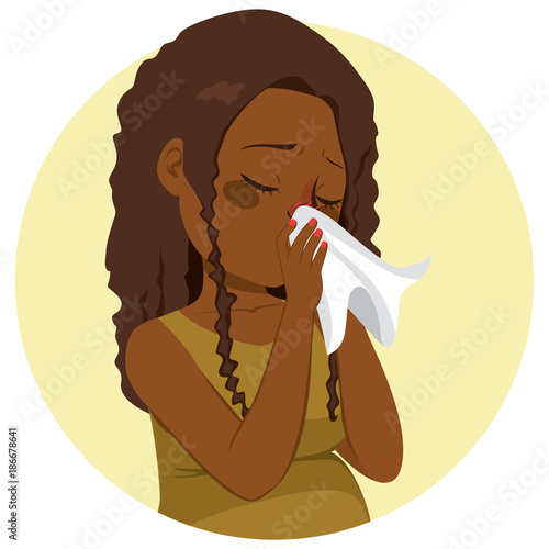 Young pregnant African woman with flu blowing nose on tissue