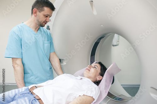 Woman in white short and blue jeans with doctor in hospital