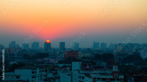 City views at sunset  Sun at the top of the building