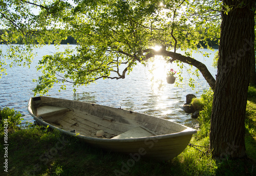 Rowboat by the lake in bright sunlight