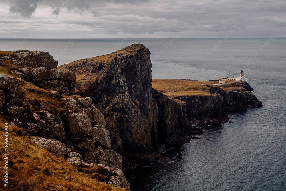 Scenic view of Neist Point Lighthouse on coastal hill†near sea Scenic view of Neist Point Lighthouse on coastal hill†near sea