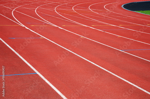 texture of run red track way in sport competition stadium background