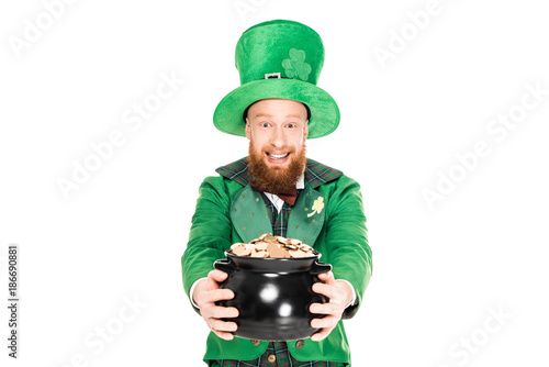 excited leprechaun in green suit holding pot of gold, isolated on white photo