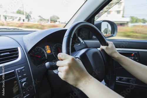 Driving car hands on steering wheel.