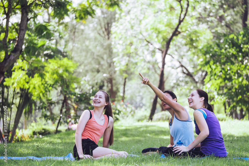 Activities in the family, mother and daughter relaxing in the park after practicing yoga. Activities in the family, mother and daughter relaxing in the park after practicing yoga.