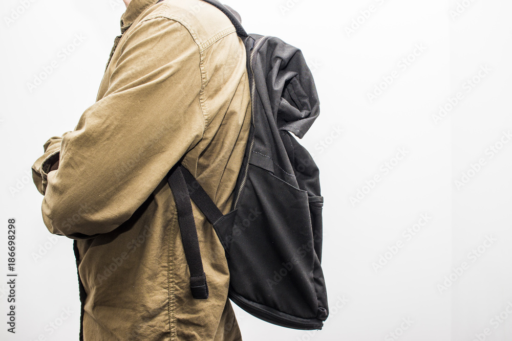 Man with black backpack are ready for travel isolated on the white background. Tourism concept. Selective focus and shallow DOF. Man with black backpack are ready for travel isolated on the white background. Tourism concept. Selective focus and shallow DOF.