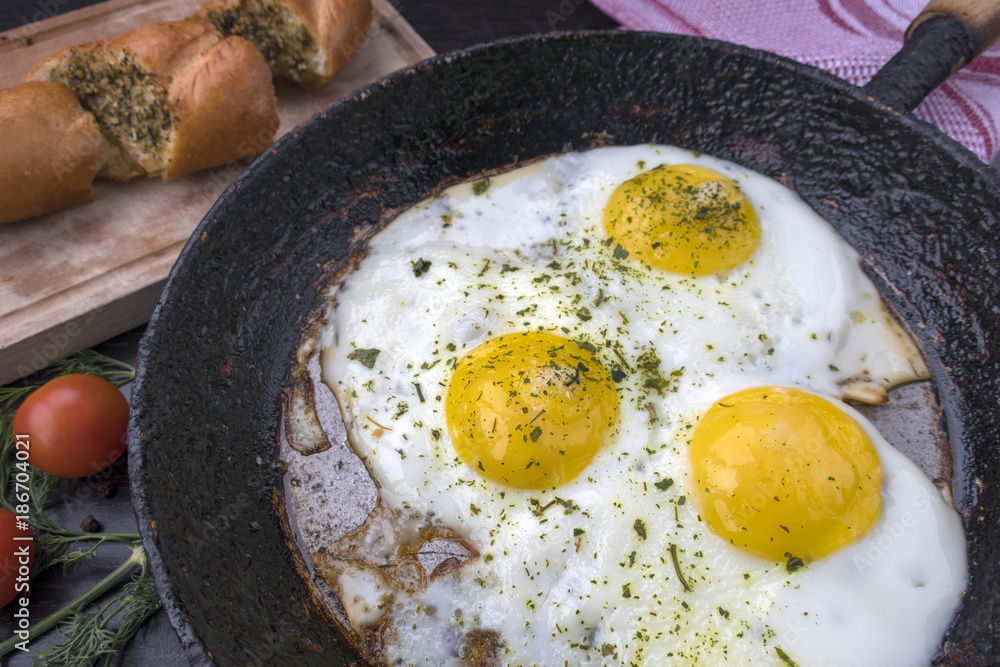 appetizing fried eggs in an old frying pan appetizing fried eggs in an old frying pan