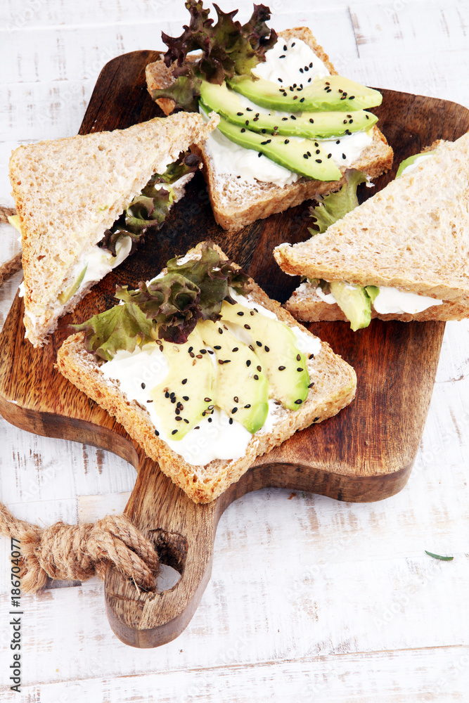Sandwich with avocado and sesame - healthy breakfast concept Sandwich with avocado and sesame - healthy breakfast concept