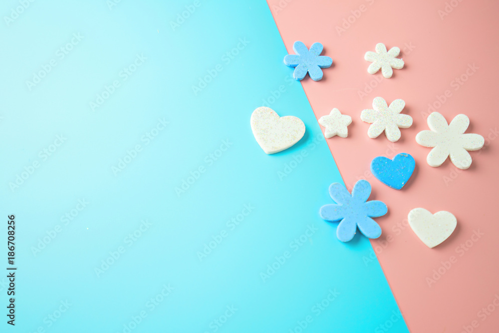 Flat lay design of heart on pink and blue background.