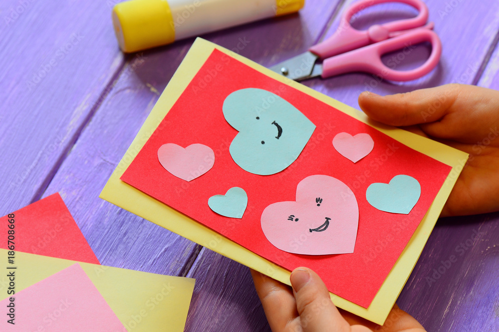 Εκτύπωση καμβά Child is holding a Valentines card in his hands