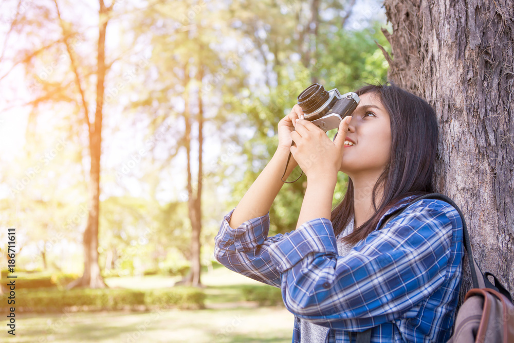 Portrait of happy Asian woman taking photos with a DSLR camera Portrait of happy Asian woman taking photos with a DSLR camera