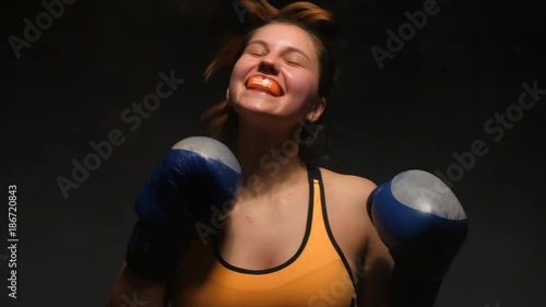 Portrait smiling woman boxer with protective mouthguard looking in camera photo