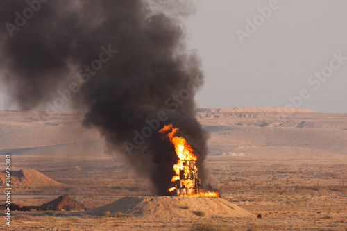 Fire and black smoke of burning oil during a fire power demonstartion of the Israeli Defence Forces in the Negev Desert photo