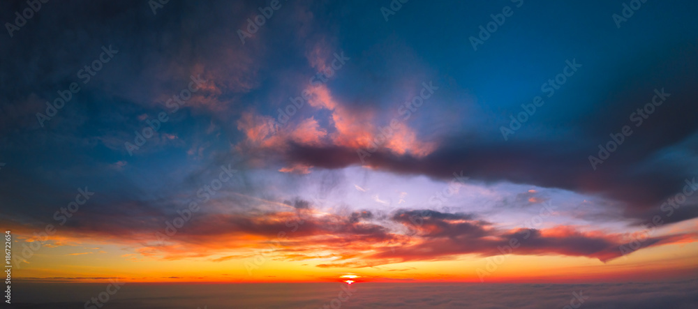 Panoramic aerial view of flying between the cloud at sunset