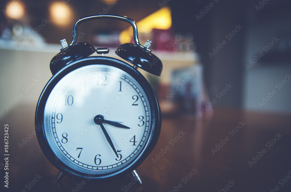 Retro alarm clock on wood table Retro alarm clock on wood table