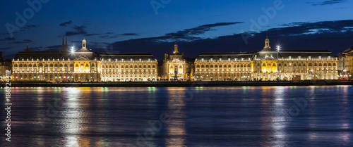 France, Nouvelle-Aquitaine, Bordeaux, Place de la Bourse across Garonne River at night photo