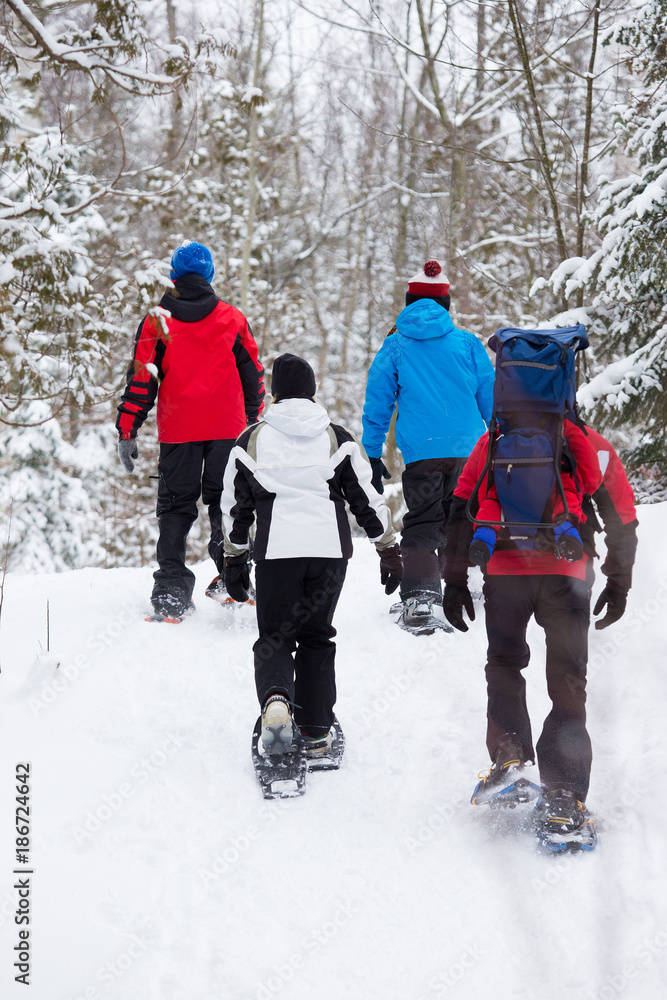 Family snowshoes in snow in Canada