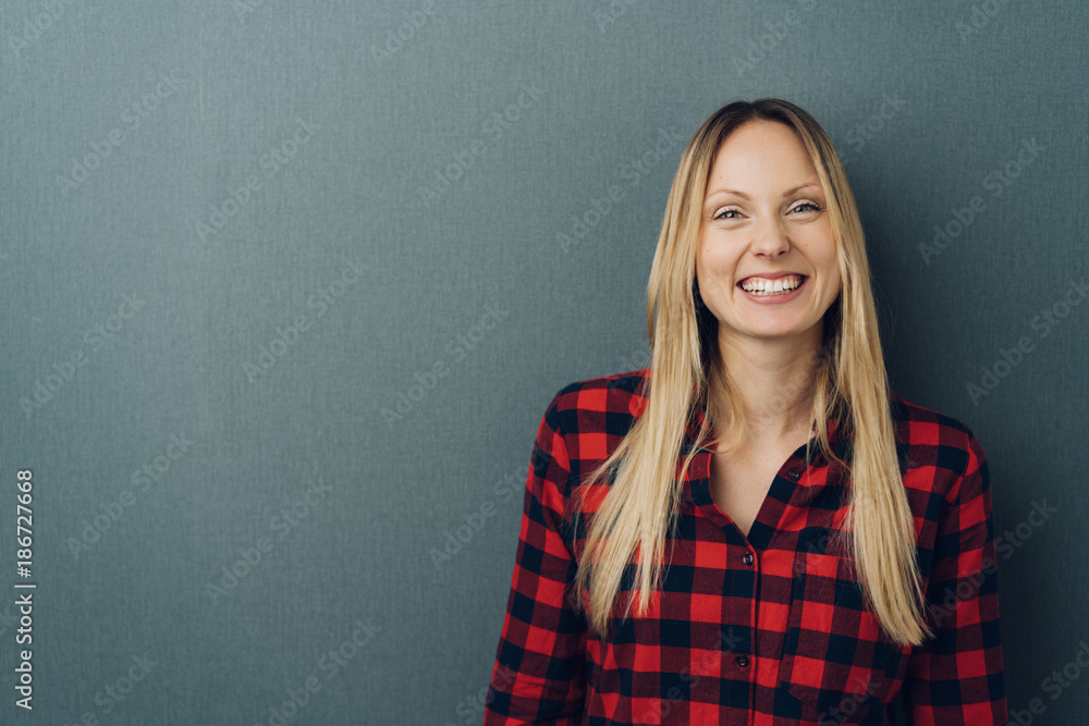 Happy young woman with a beaming cheerful smile Happy young woman with a beaming cheerful smile