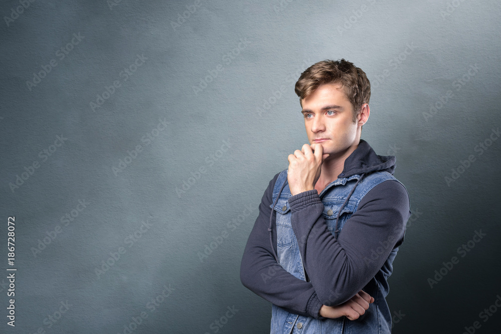 Casual caucasian young man with thoughtful expression