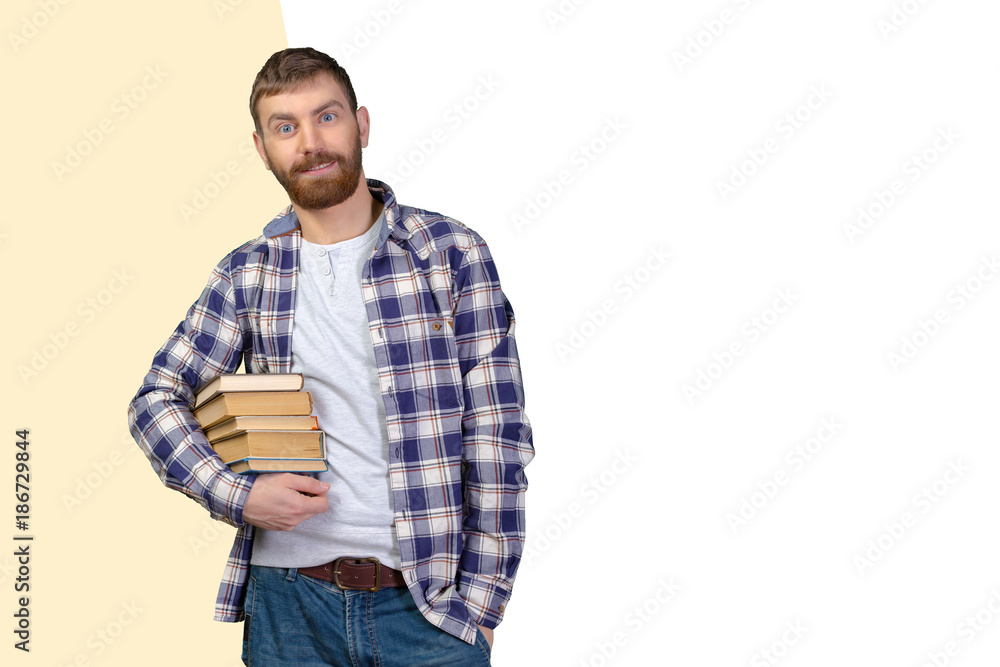 Young Man Holding Stack Of Books Young Man Holding Stack Of Books