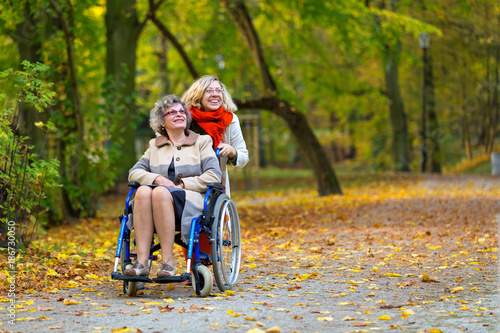 older woman on wheelchair with young woman in the park