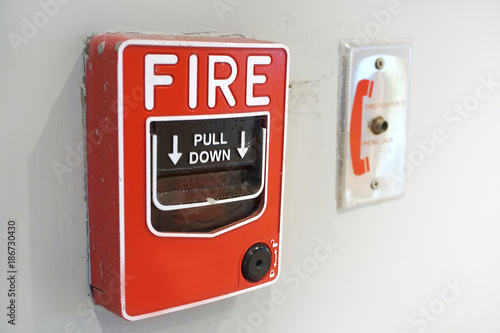 The red fire alarm and equipment on the white wall.